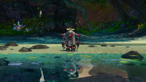 Ein Miniaturgolem des Charakters Blish steht an einem Strand am Wasser. Er ist grau und mit roten Edelsteinen besetzt, und über seinem Kopf leuchtet ein goldener Heiligenschein.